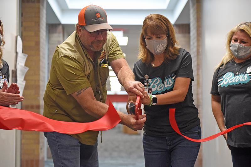 Ron Landreth and Dr. Jeanette Gerault cut a red ribbon welcoming staff to campus.
